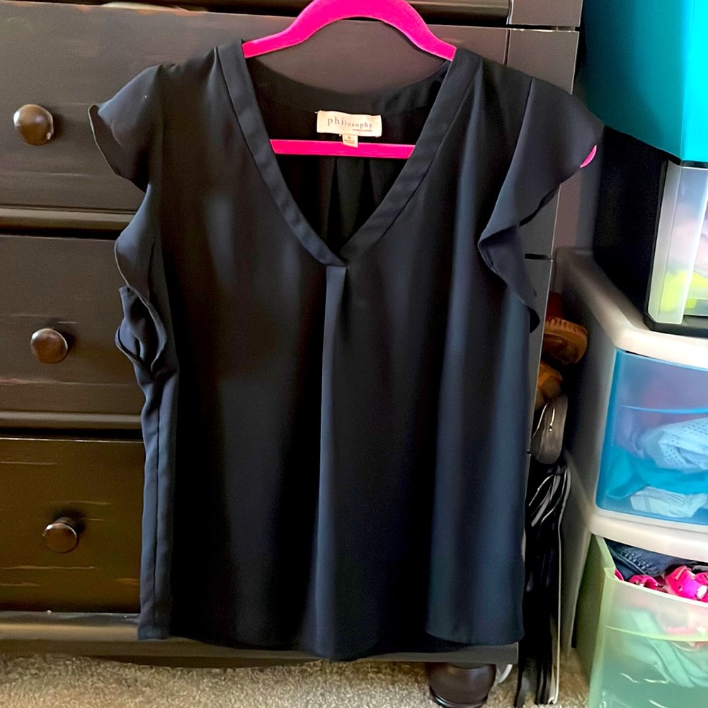 Women’s tank blouse. Flowy sleeves on the ends give slight shoulder coverage.